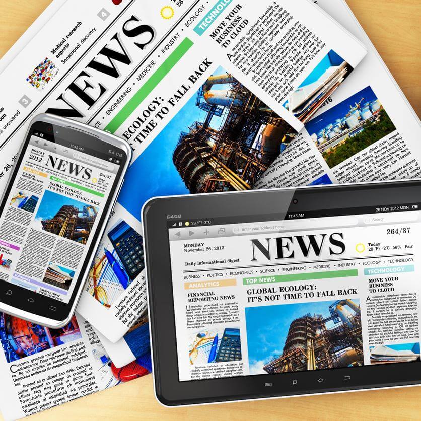 An image showing both print and digital forms of journalism